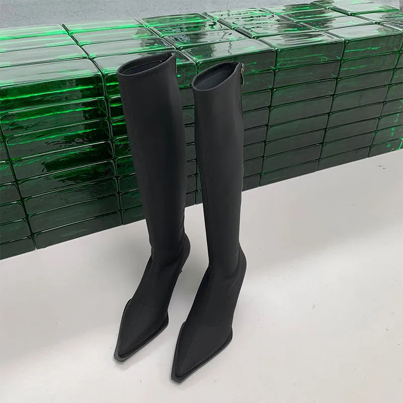 Women's black pointed toe stiletto heel boots with a back zipper, shown below the knee.