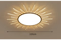 Modern round aluminium LED ceiling lamp with remote control on a white ceiling.
