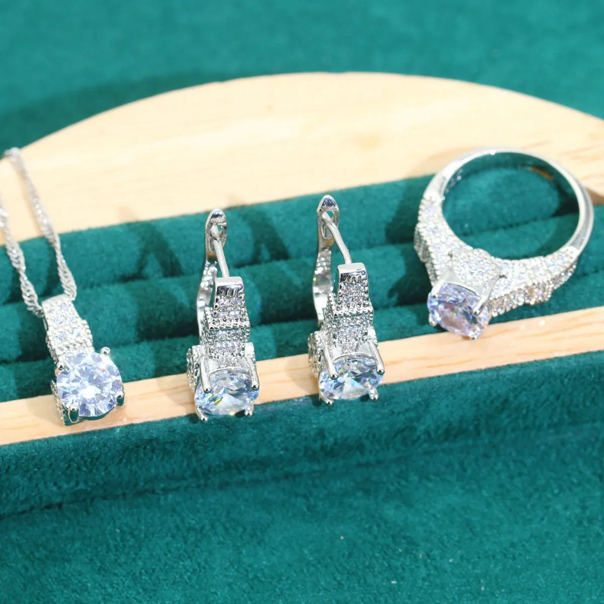 Four-piece bridal jewellery set showing zircon necklace, bracelet, earrings and ring with water wave chain design