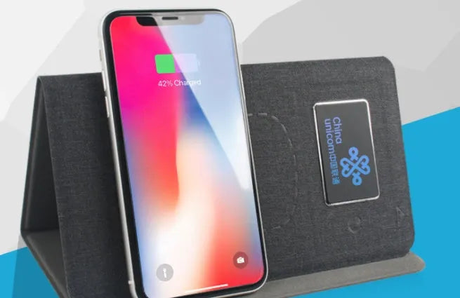 Folding wireless charging mouse pad set with Bluetooth mouse on desk, showing compact folded size