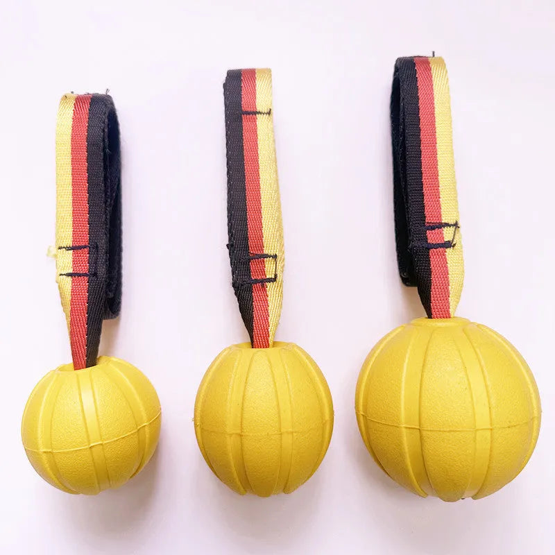 Camouflage and yellow EVA foam floating dog training balls in three different sizes on a blue background.