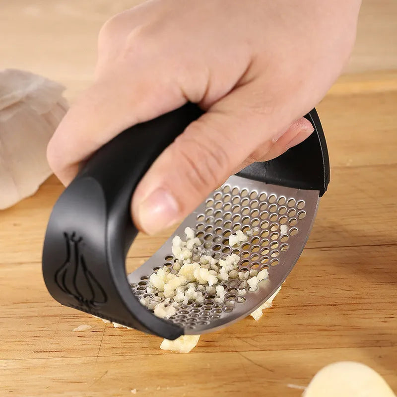 Stainless steel garlic press kitchen utensil in black, blue, green or pink colour measuring 11x7cm
