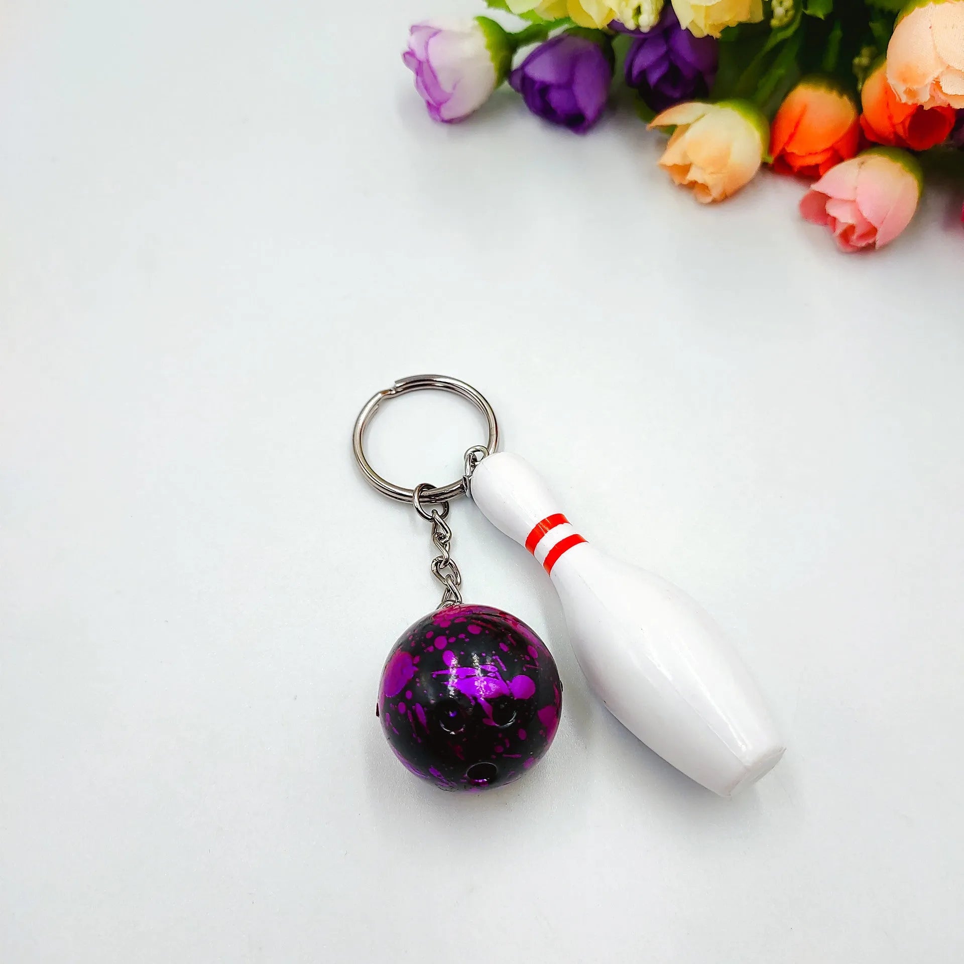 Mini simulation sports bowling pin keychain pendant in blue, dark red, green, or purple colour options.