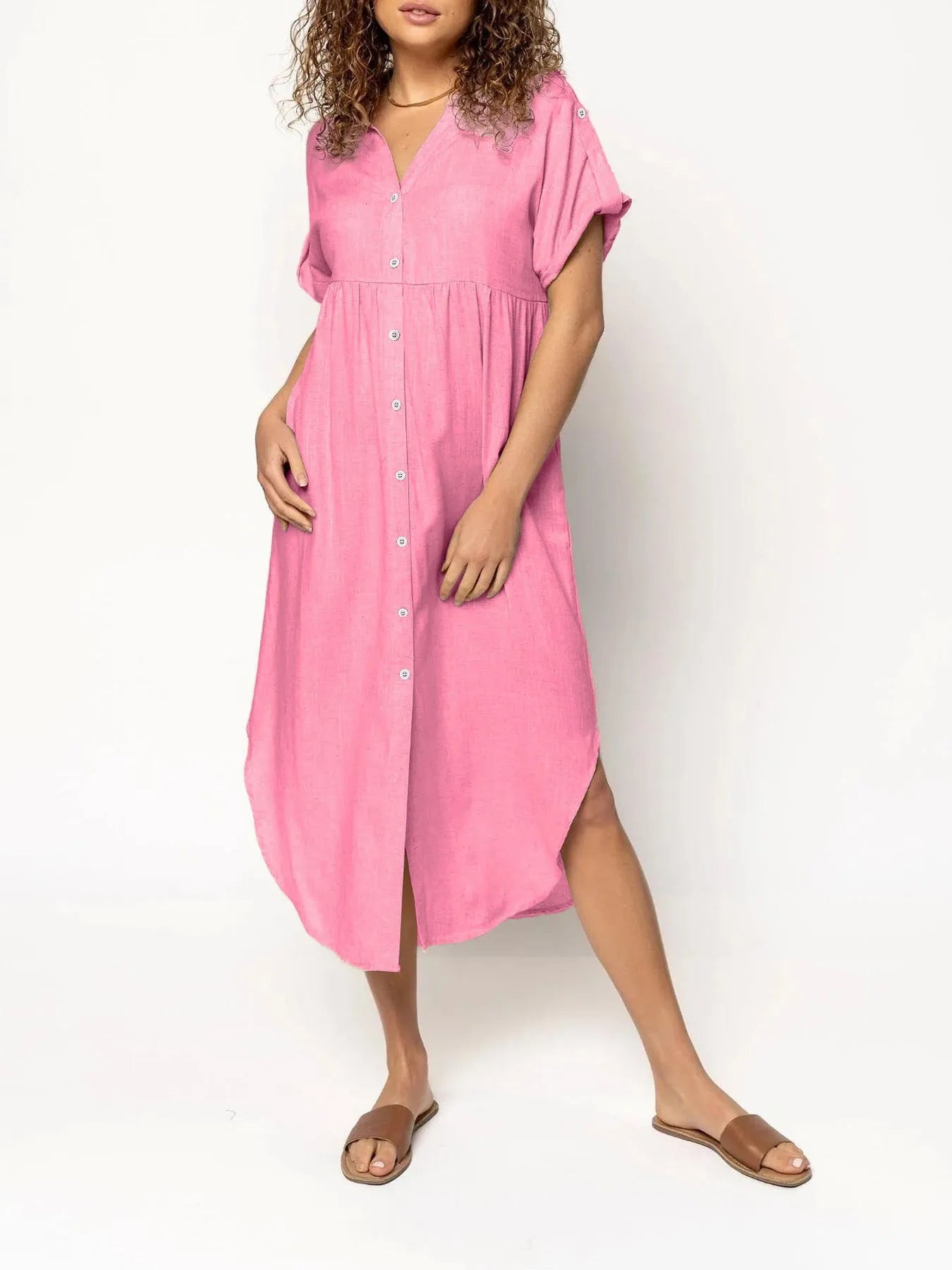 A loose-fitting, mid-length casual dress with button detail on the front, shown in a solid colour.