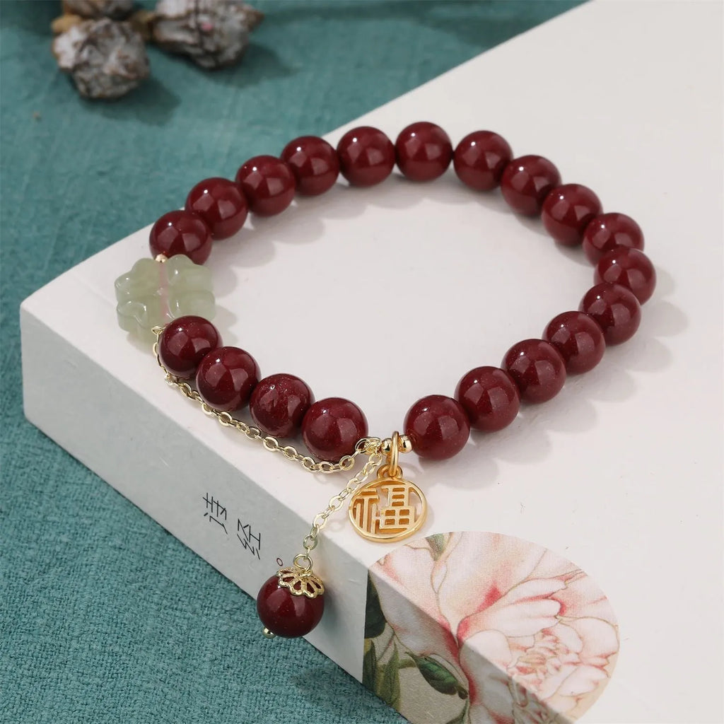 Women's national style cinnabar bracelet with fu character design and peach blossom tassel detailing