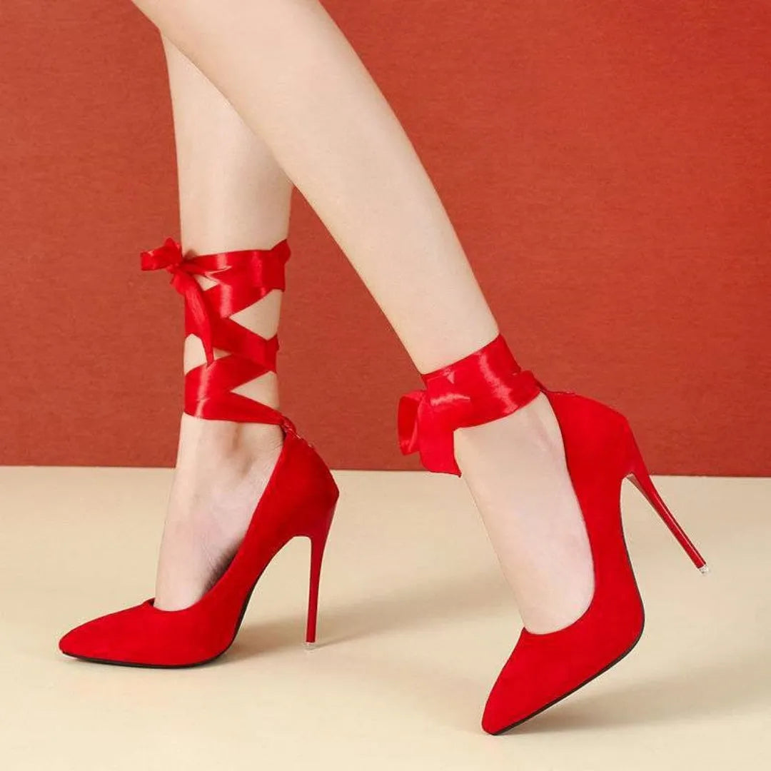 Black women's stiletto pump with thin lace strap and pointed toe on a 12cm heel.