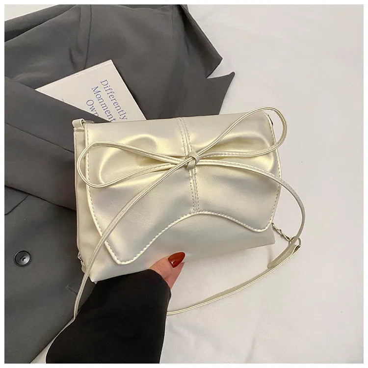 Women's black PU leather crossbody bag with horizontal square shape and visible sewing details