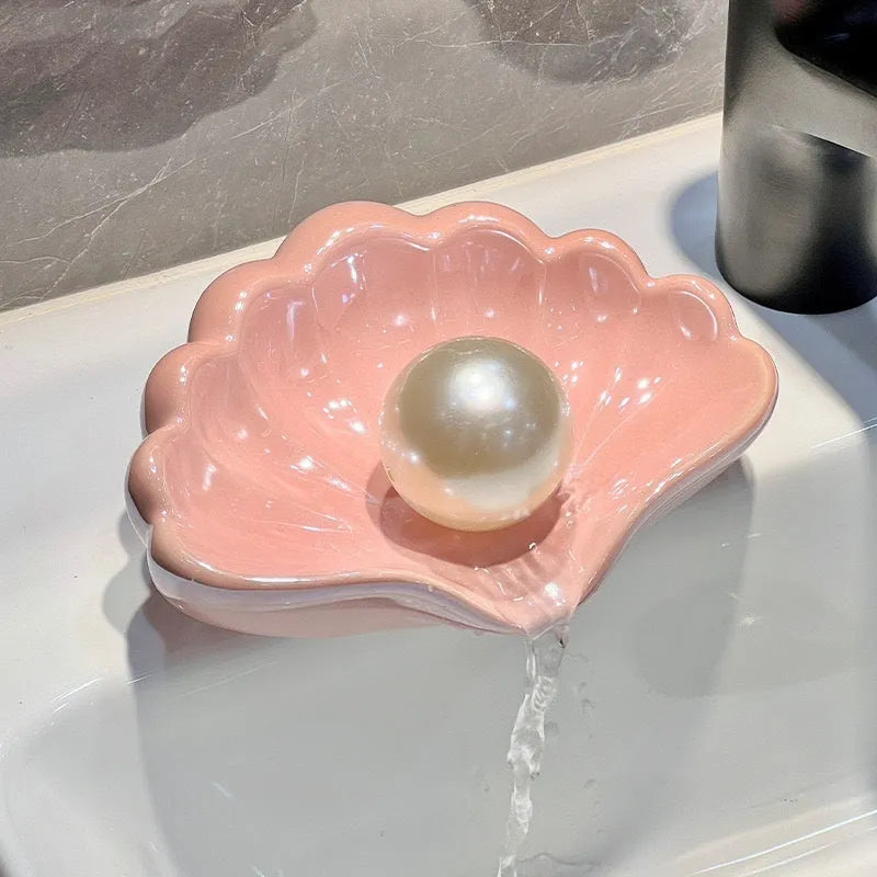 Plastic shell-shaped soap dish in pearl white or pink colour for bathroom organisation