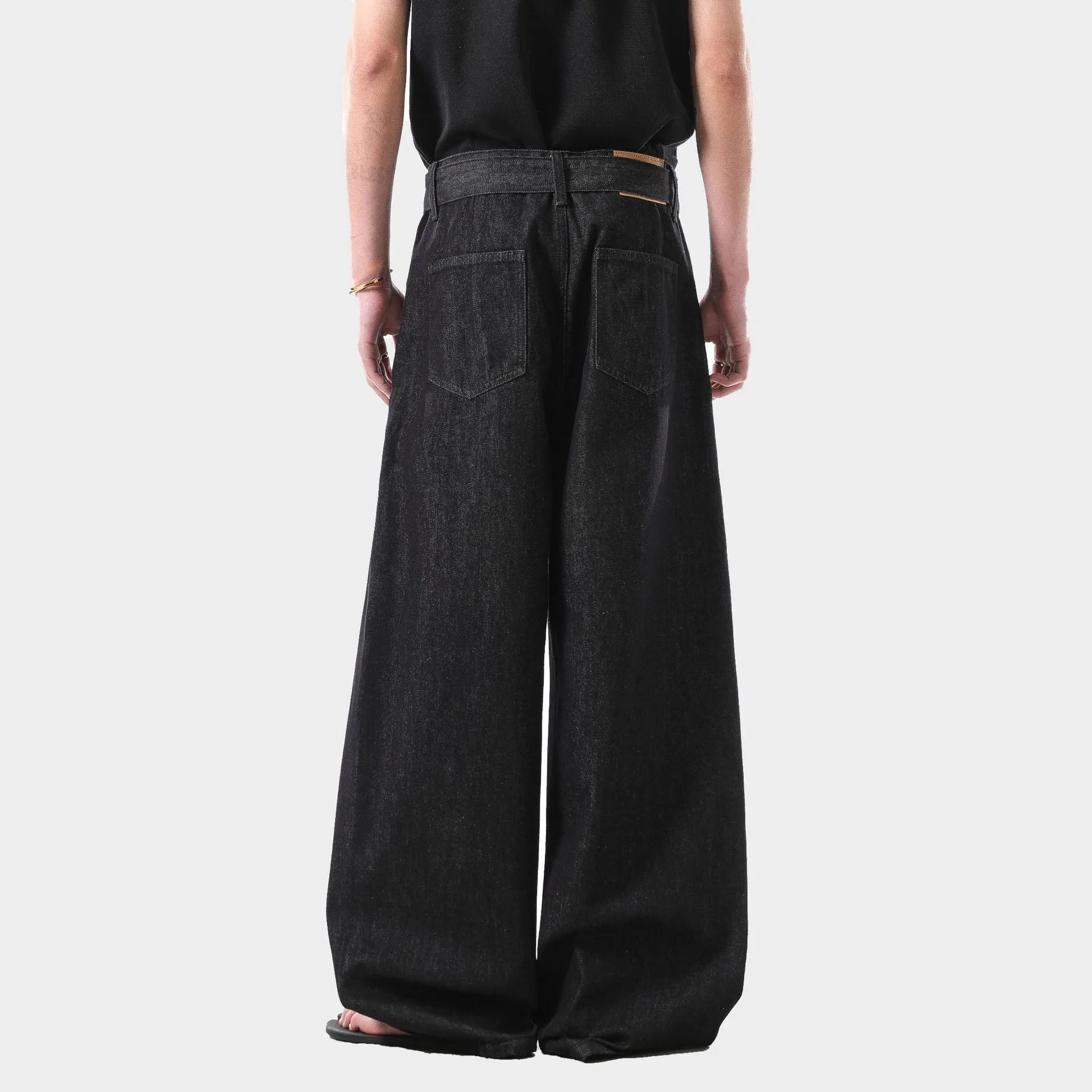 Black American retro high waist straight leg jeans with gold accents on a zip fly.