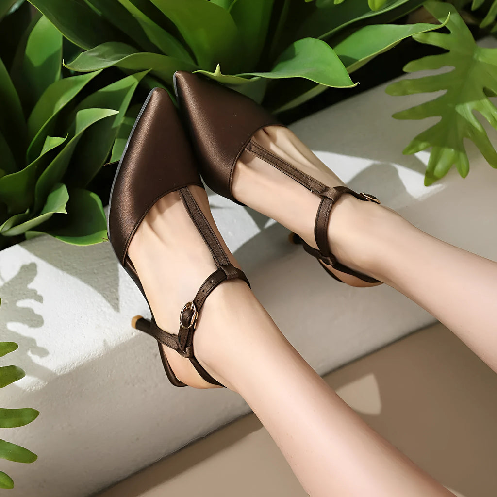 Women's pointed T-strap high heels in top grain leather, black colour, side view on plain background