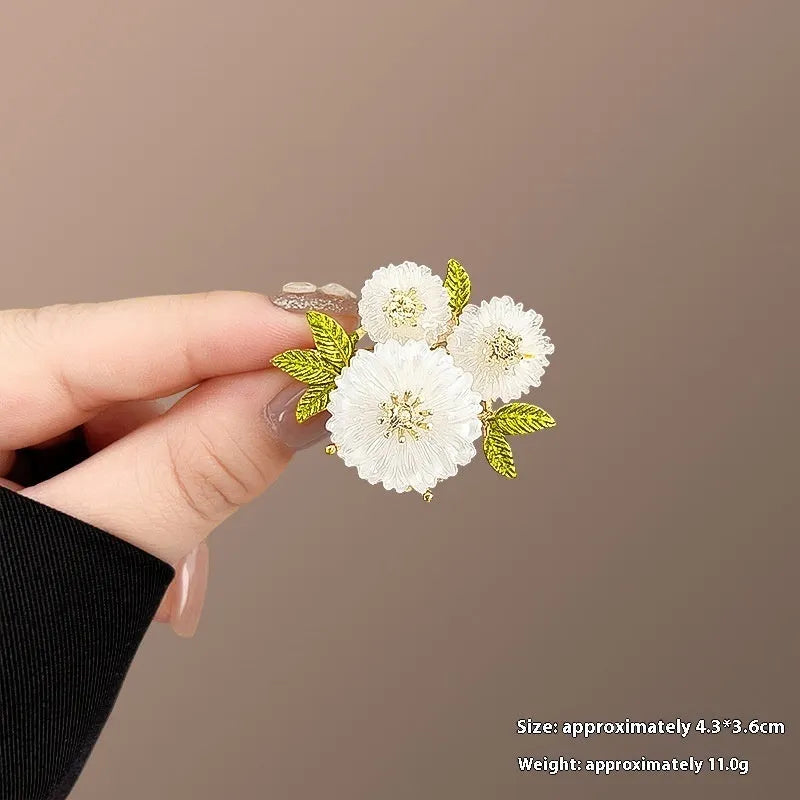 Alloy brooch in natural flower shape with electroplated finish, featuring adjustable and anti-exposure pin closure for women's coats and suits.
