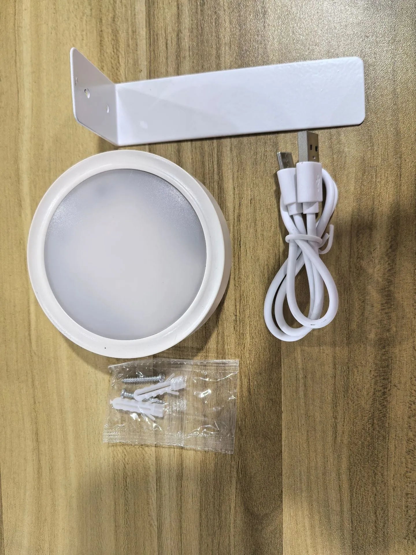 Wireless rechargeable LED painting lamp with magnetic belt attached to a metal frame, remote control nearby.