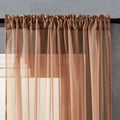 Modern pure colour cotton linen curtain in black hanging vertically with light transmission visible