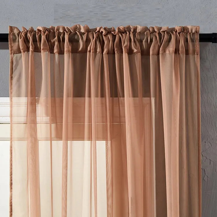 Modern pure colour cotton linen curtain in black hanging vertically with light transmission visible