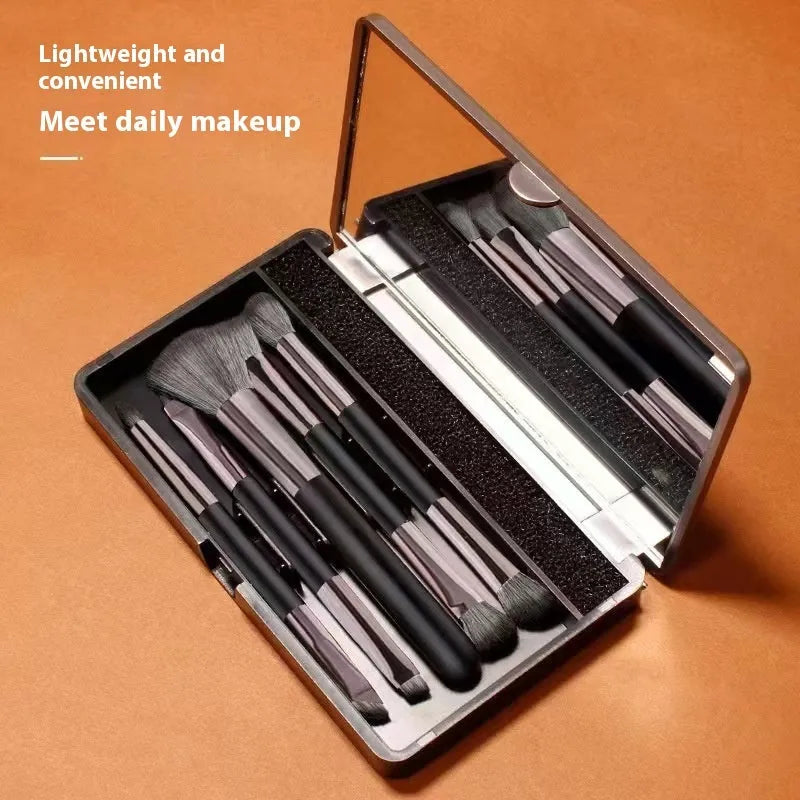 Multifunctional makeup brush suit with mirror showing artificial fibre brushes in silver or gold handles