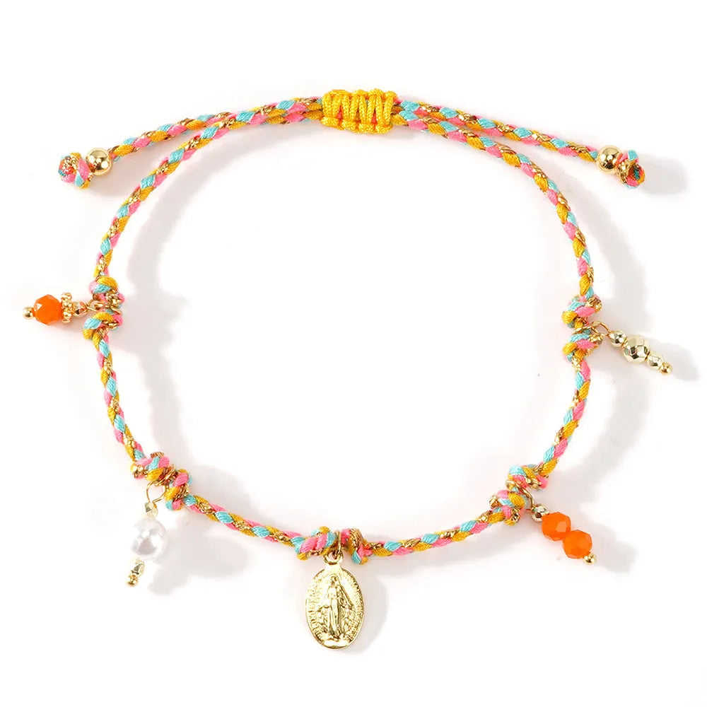 Close-up of a hand-woven colourful braided rope bracelet with an adjustable strap tag, showing ethnic style design.