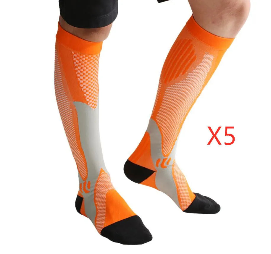 Graduated compression socks for men and women in black, shown laid flat.