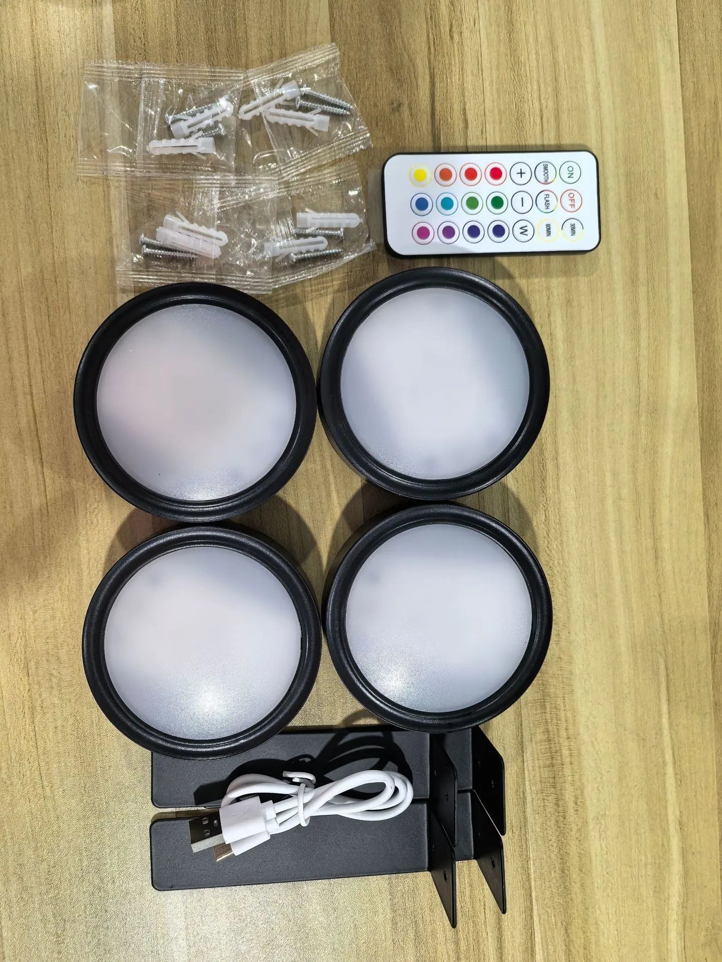 Wireless rechargeable LED painting lamp with magnetic belt attached to a metal frame, remote control nearby.