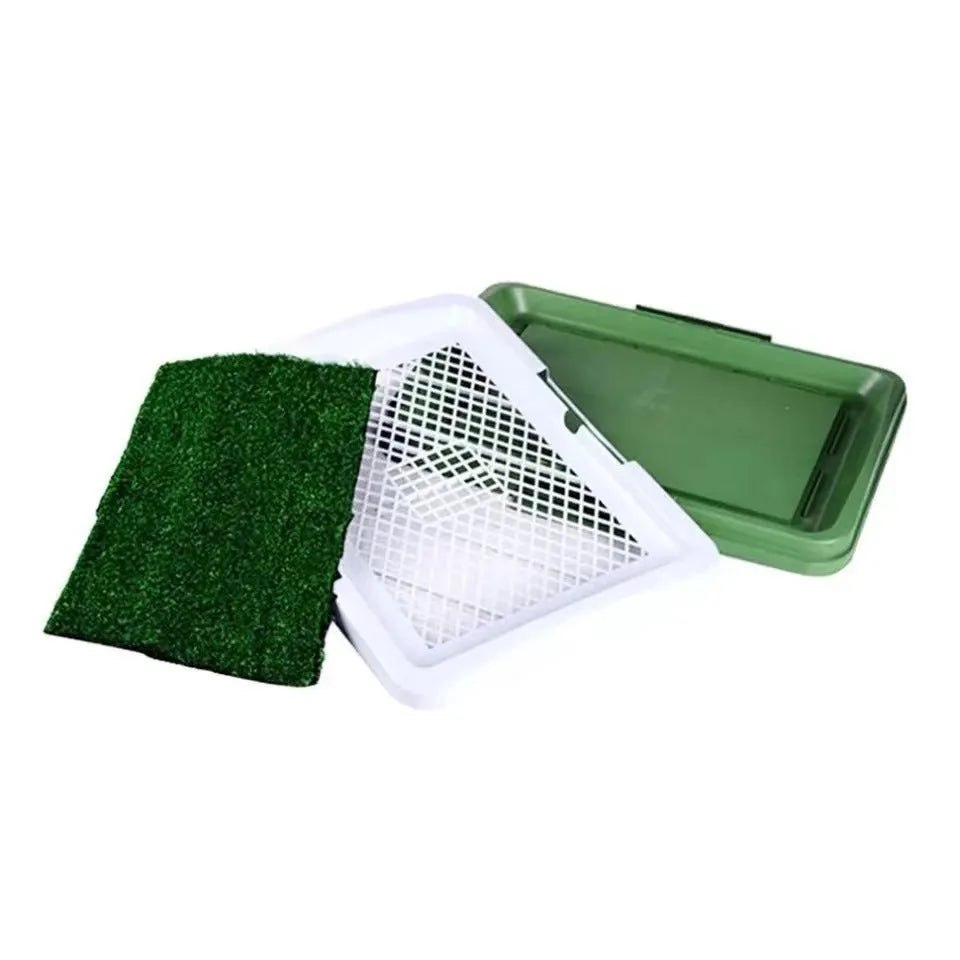 Green synthetic grass dog toilet training tray with plastic base and absorbent pad layer.