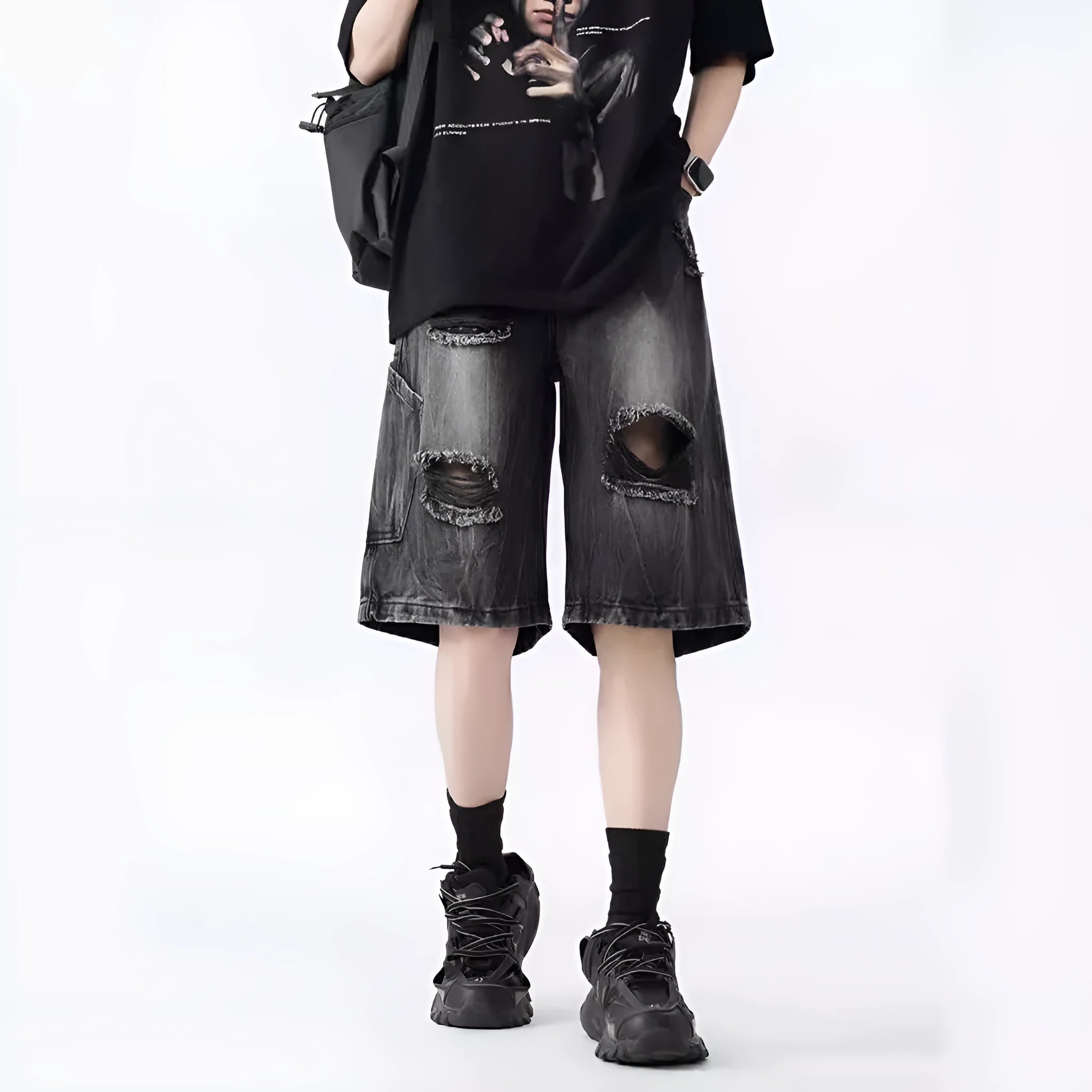 Washed denim shorts with ripped detailing in loose retro style, available in black or blue