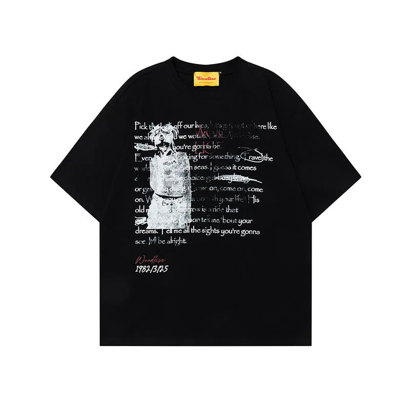 Man modelling a black loose-fit pure cotton T-shirt with a white printed letter pattern and raglan short sleeves