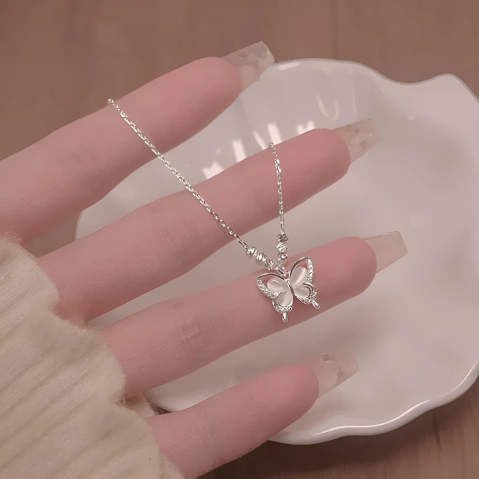 Women's square line opal butterfly necklace in 925 silver with a cross chain, shown in silver colour.