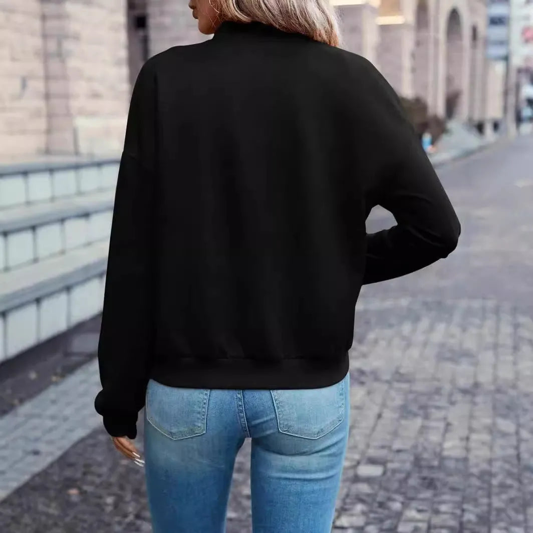 Women's solid black long sleeve zip jacket on a hanger, front view.