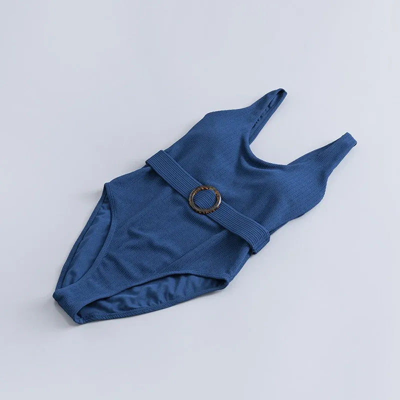 Navy blue women's one-piece swimsuit with triangle neckline and built-in chest pads