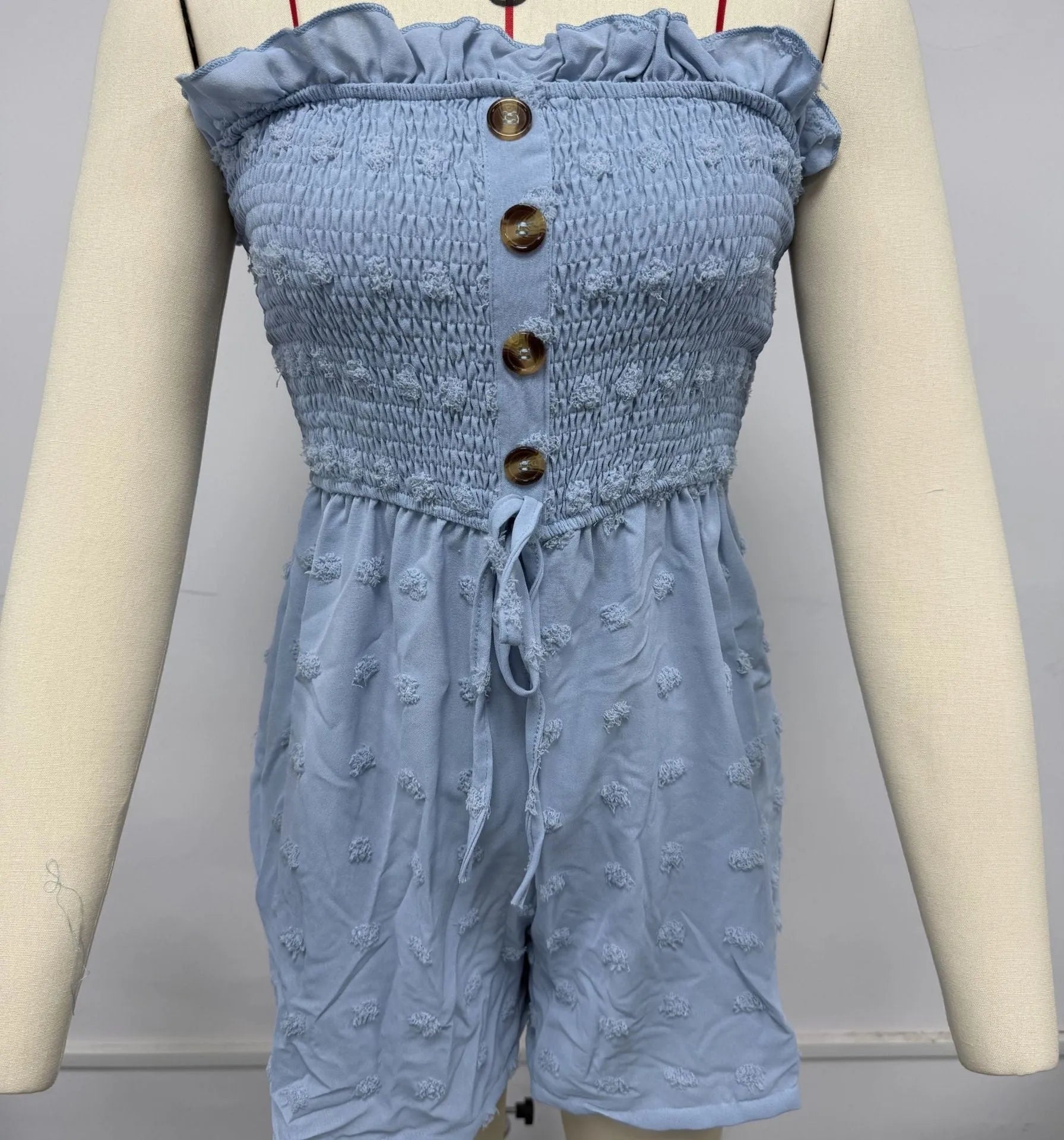 Women's blue off-shoulder jumpsuit with button detail and fifth pants length