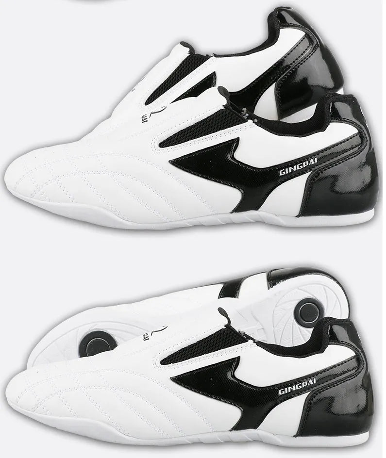 Black and white children's martial arts training shoes with a soft sole and widened design.