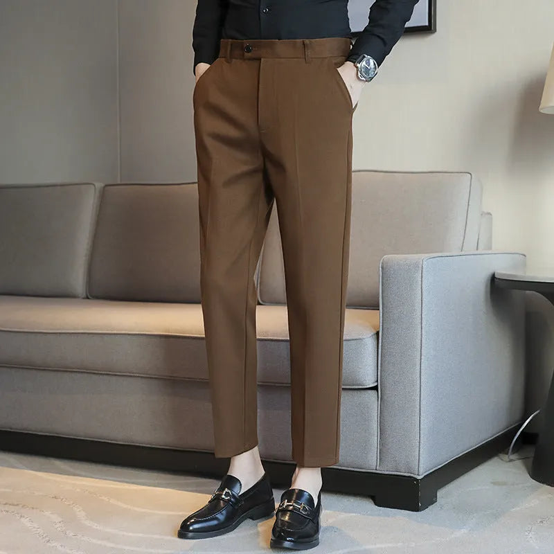 Men's brown straight-leg corduroy trousers with an elasticated waistband laid flat.
