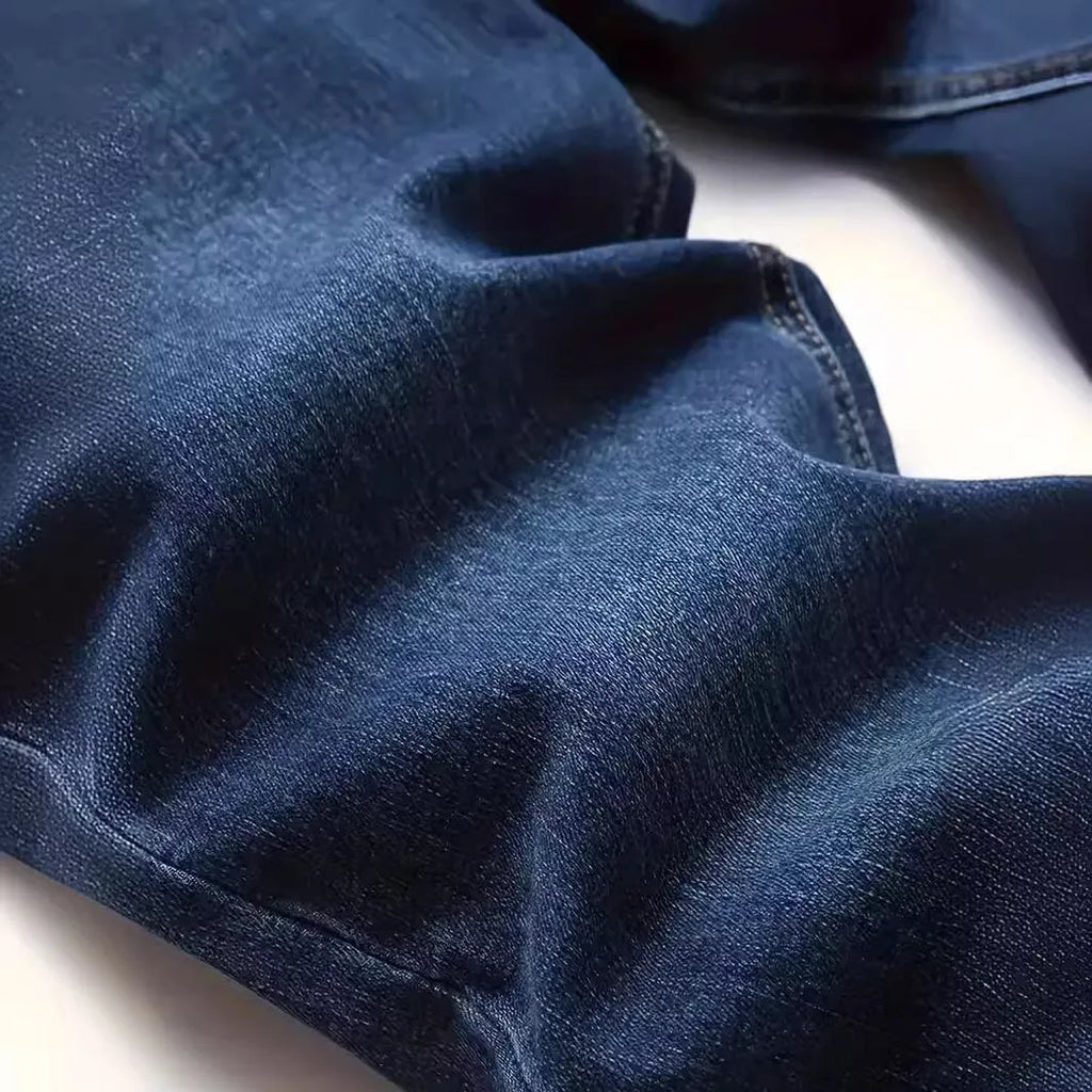 Men's dark blue slim fit casual jeans with mid waist and zipper fly opening