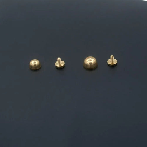 Brass decorative foot nail buckles in round and bucket shapes, sizes 10x6mm and 12x7mm.
