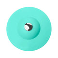 UFO-style silicone press sink drain cover in white on a modern kitchen sink