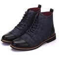 Men's black leather motorcycle boots with a silver buckle detail on a rubber sole.