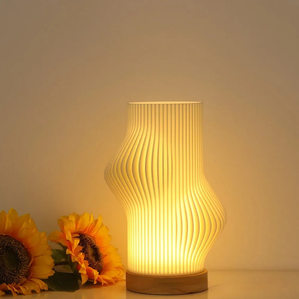 3D printed cylindrical vase night lamp in wood colour finish on a modern bedside table