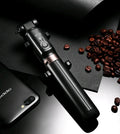 Aluminium Bluetooth selfie stick with tripod base and remote control next to a smartphone.