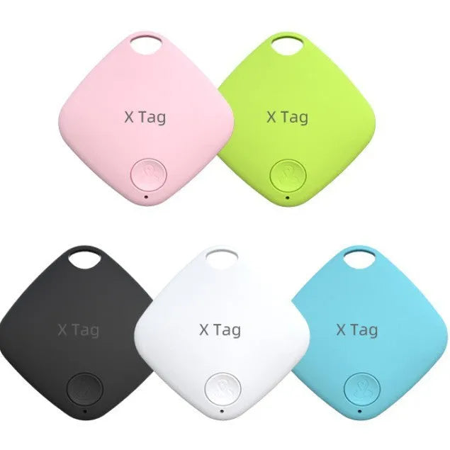 Small black Bluetooth tracker with key ring, shown next to a set of keys to illustrate size.