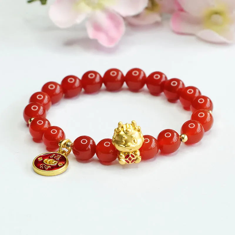 Close-up of a red agate beaded bracelet with a Chinese zodiac dragon charm on a wrist.