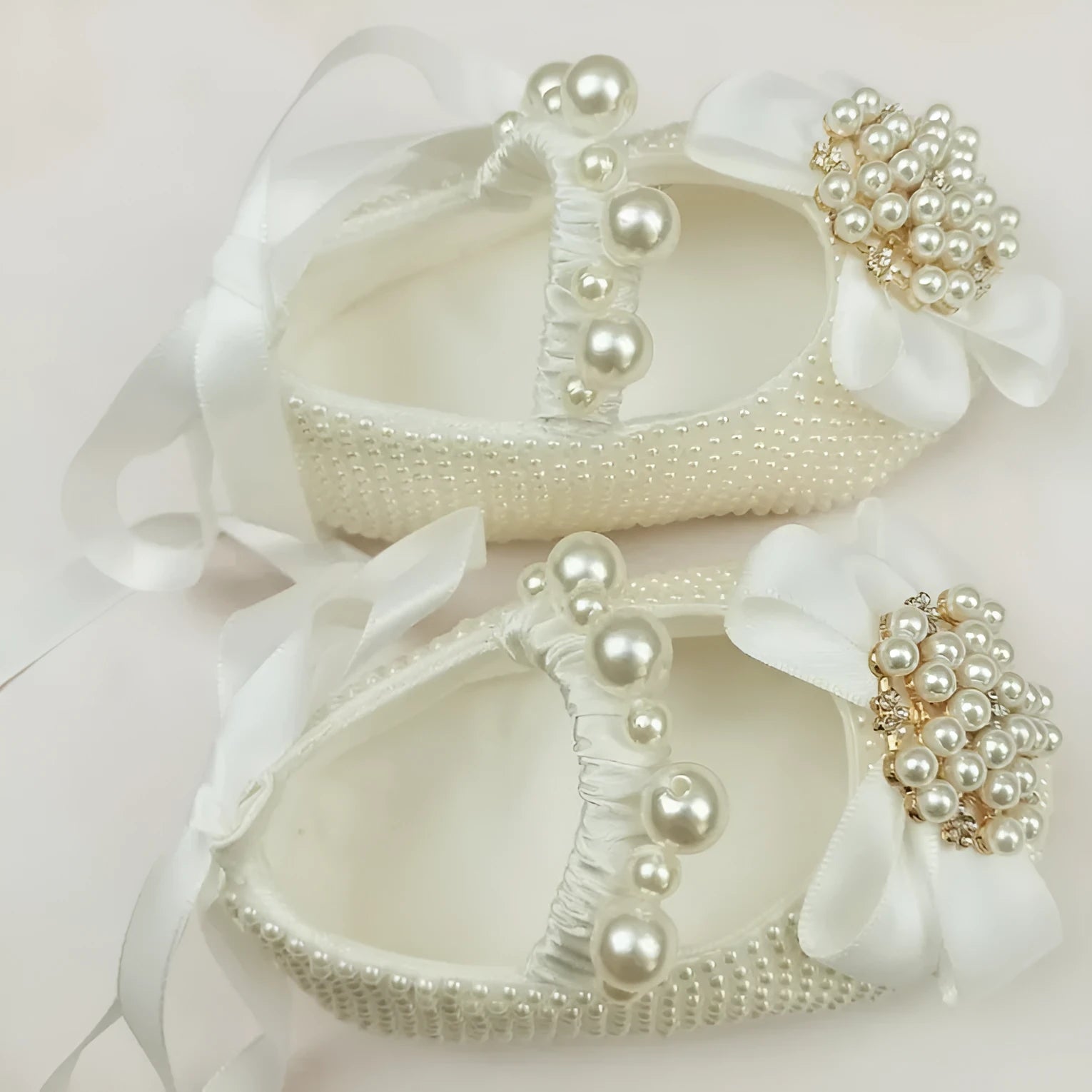 Milky white handmade soft sole cloth princess shoes with pearl detailing and lace-up closure for babies
