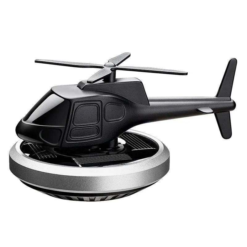 Silver metal solar helicopter car air freshener ornament rotating on dashboard