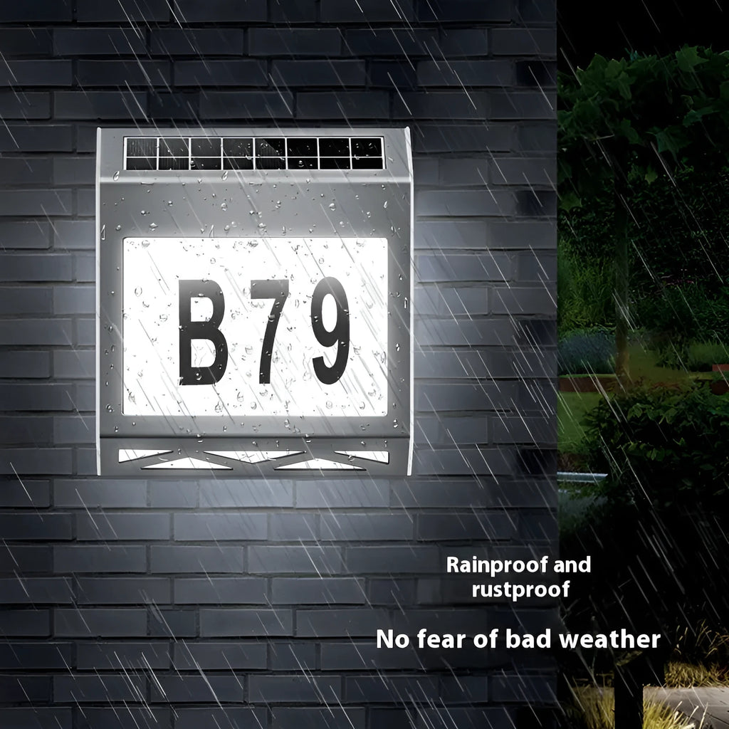 Solar powered doorplate light with LED indicator in black or silver finish, measuring 180x50x200mm