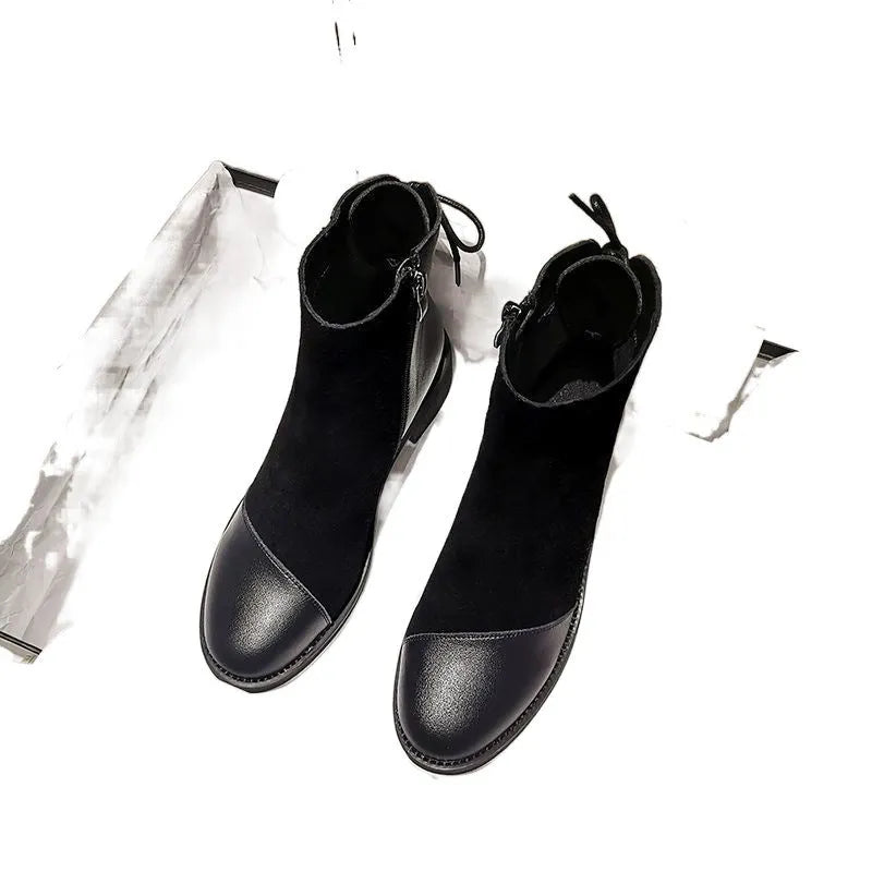 Black women's knee-high Martin boots with side zipper, round toe, and short stout heel.