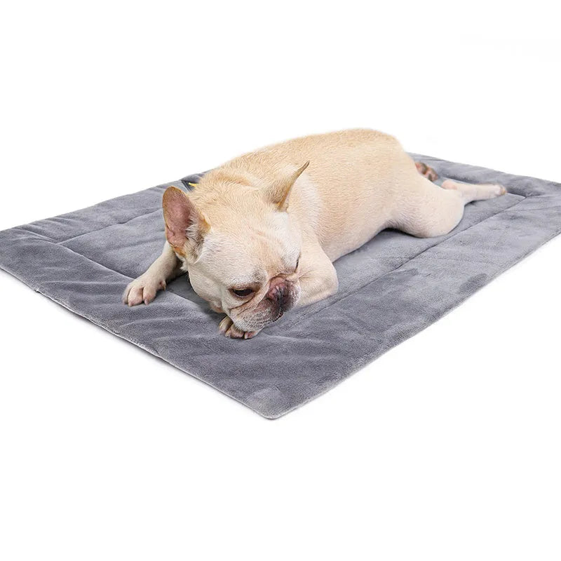 Self-heating pet mat in brown with soft fleece surface and non-slip base on wooden floor