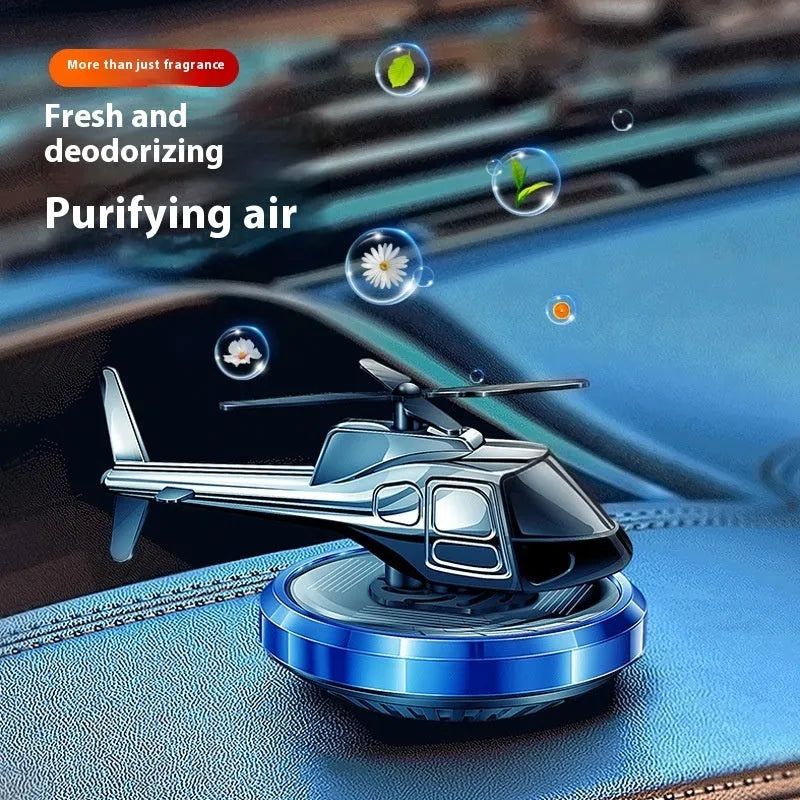 Silver metal solar helicopter car air freshener ornament rotating on dashboard
