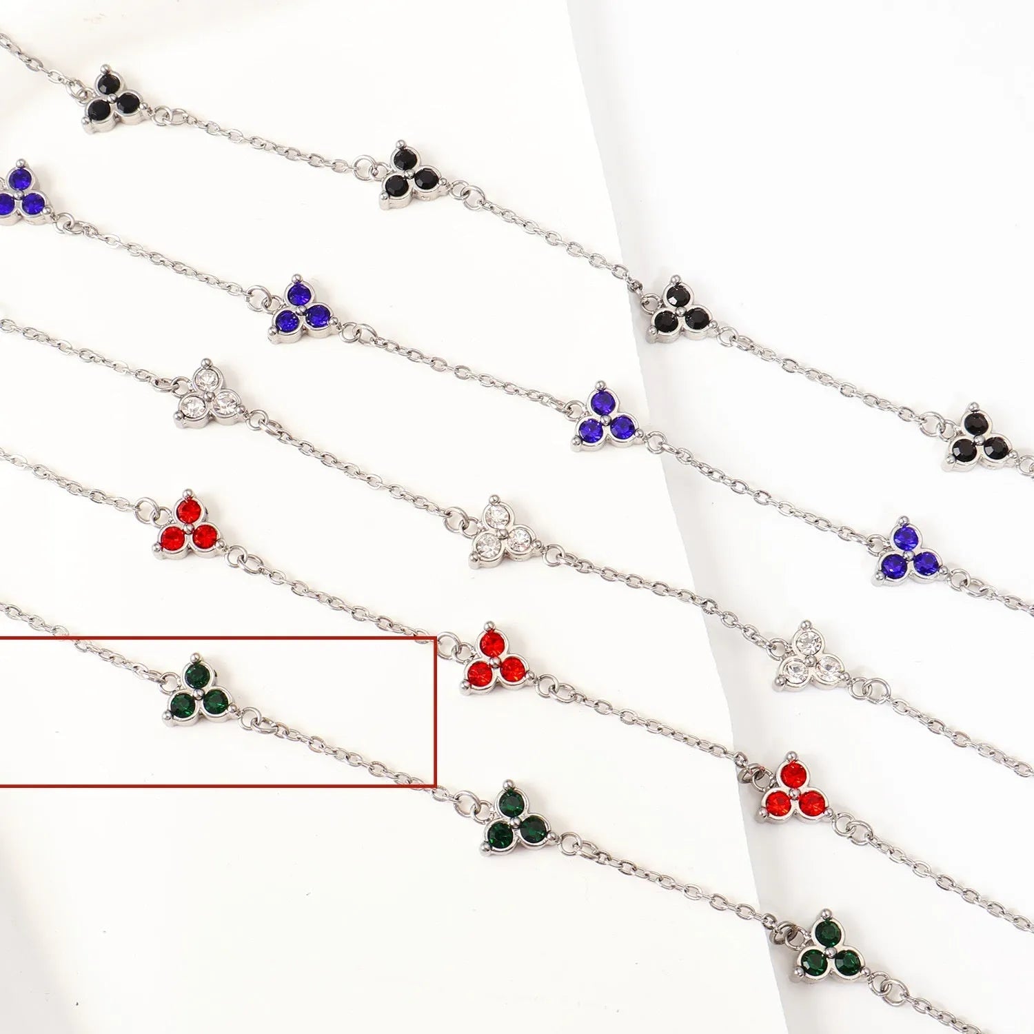 Women's stainless steel geometric bracelet with triangle elements and coloured stone settings