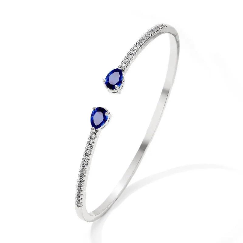 Copper bracelet with inlaid zircon treatment in blue and white colour options