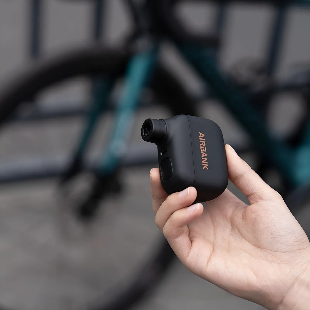 Black AS100 electric bicycle tyre inflator pump with USB charging cable and waterproof bag