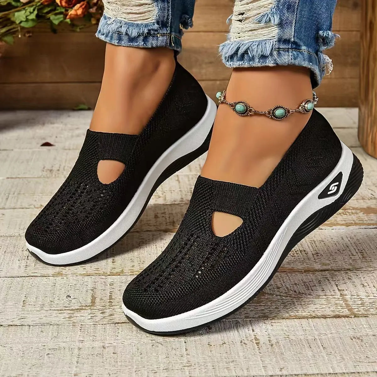 Women's black casual mesh shoes with T-strap and flat soft sole.