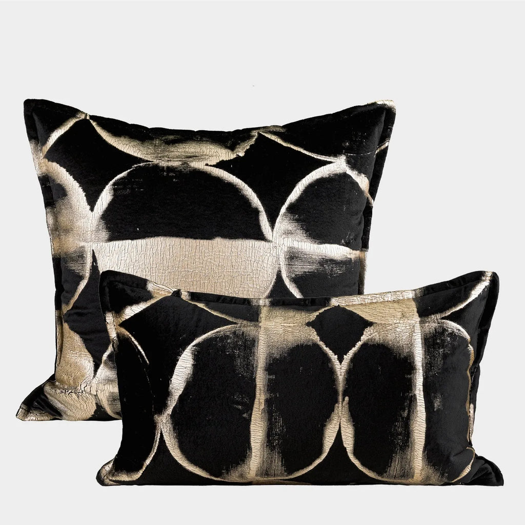Black gold abstract pattern decorative flannel cushion on a sofa, showing removable cover.